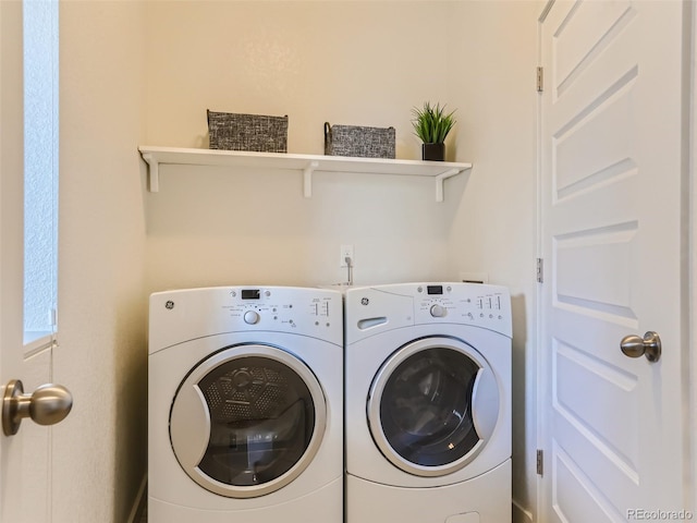 clothes washing area with washer and dryer