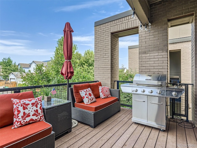 deck with grilling area and outdoor lounge area