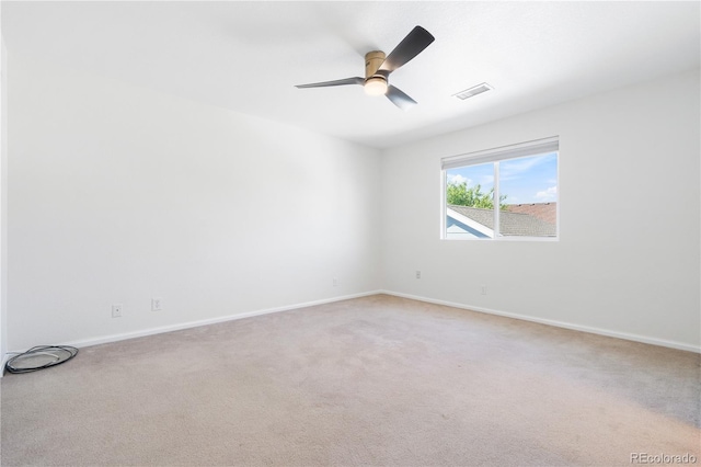 carpeted spare room featuring ceiling fan