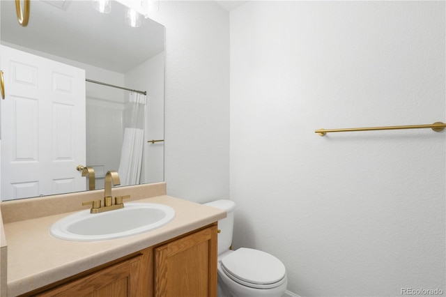 bathroom with vanity, toilet, and a shower with shower curtain