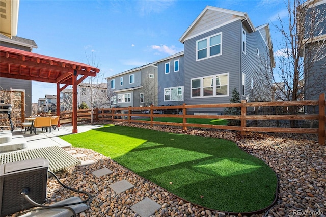 back of house with a yard and a patio