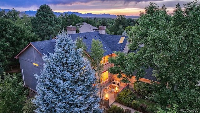 aerial view at dusk featuring a mountain view