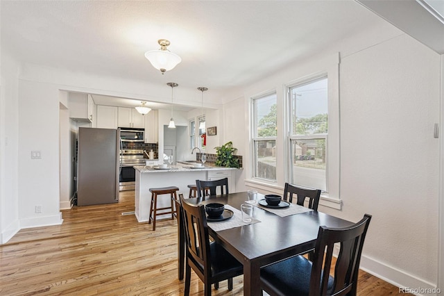 2800 N Fillmore St, Denver, CO 80205 - dining area featuring light wood-style floors and baseboards