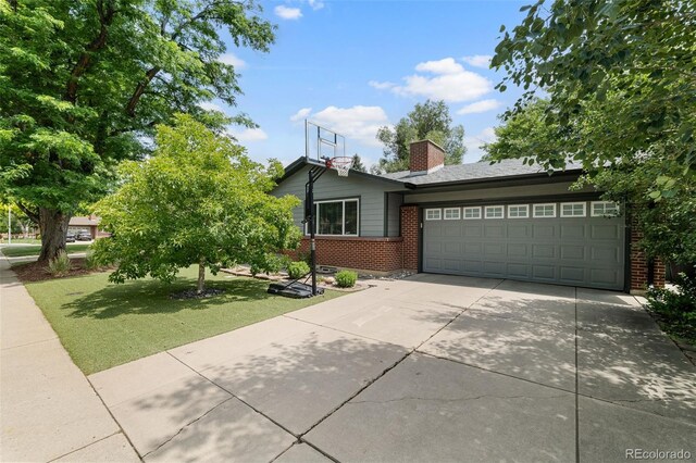 2672 S Magnolia St, Denver, CO 80224 - view of front of house featuring brick siding, concrete driveway, an attached garage, a front yard, and a chimney