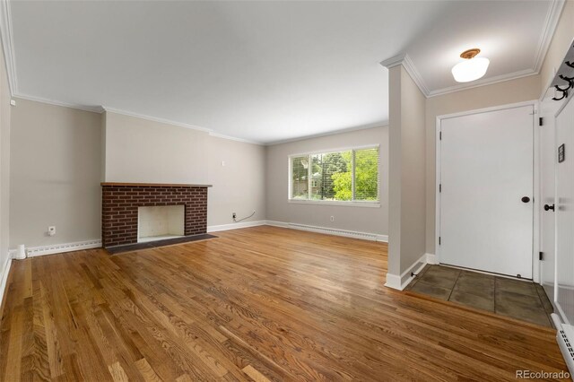 2672 S Magnolia St, Denver, CO 80224 - entrance foyer with crown molding, wood finished floors, baseboard heating, and a fireplace