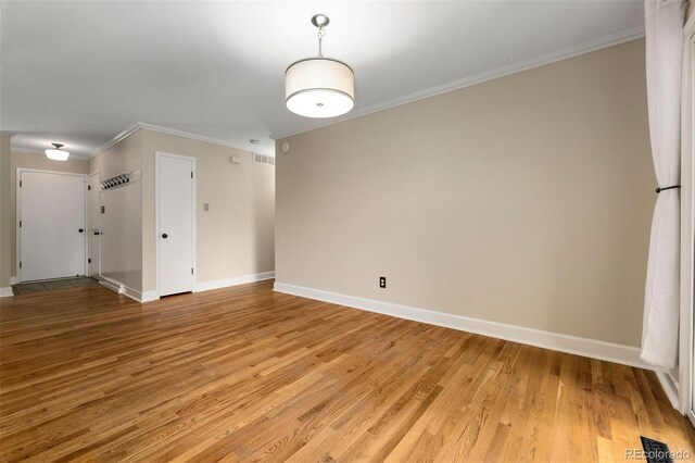 2672 S Magnolia St, Denver, CO 80224 - spare room featuring ornamental molding and light wood-style floors