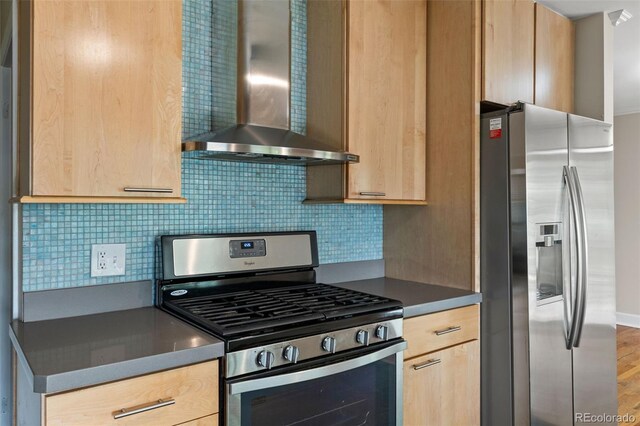 2672 S Magnolia St, Denver, CO 80224 - kitchen with stainless steel appliances, wall chimney exhaust hood, light brown cabinets, decorative backsplash, and wood finished floors