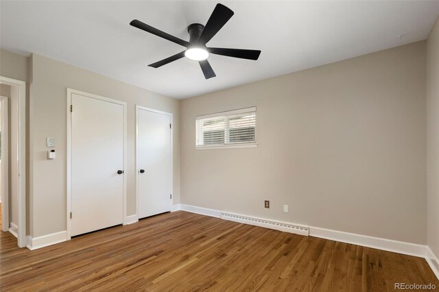 2672 S Magnolia St, Denver, CO 80224 - unfurnished bedroom with a baseboard radiator, light wood-style flooring, and ceiling fan