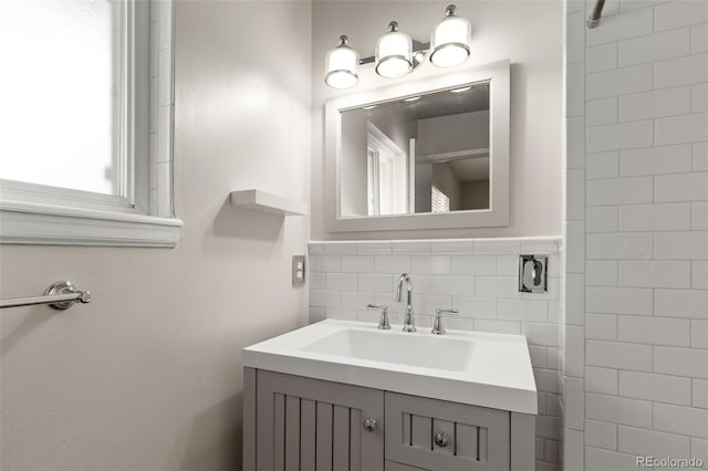 2672 S Magnolia St, Denver, CO 80224 - bathroom featuring vanity and decorative backsplash