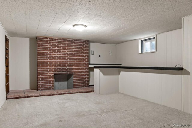 2672 S Magnolia St, Denver, CO 80224 - below grade area featuring carpet flooring, a brick fireplace, and a decorative wall