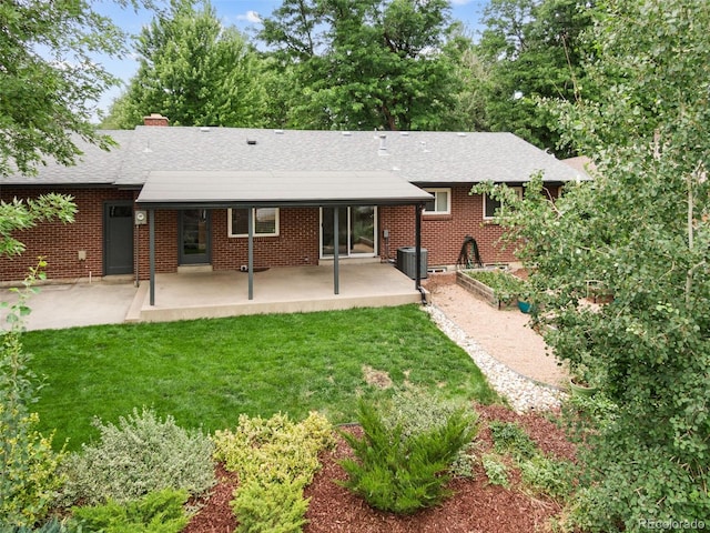 2672 S Magnolia St, Denver, CO 80224 - rear view of property featuring a patio, a yard, roof with shingles, and a chimney
