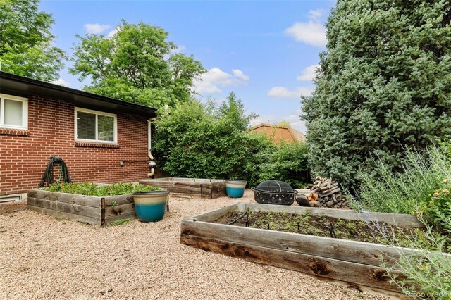 2672 S Magnolia St, Denver, CO 80224 - view of yard with a vegetable garden and a fire pit