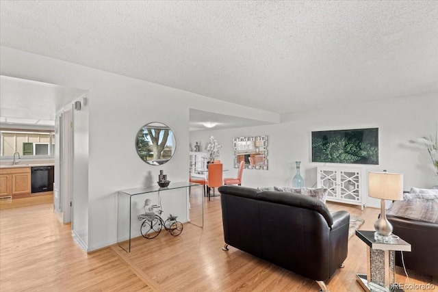 living room featuring light wood-style flooring and a textured ceiling