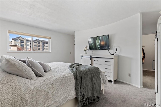 bedroom with baseboards and carpet