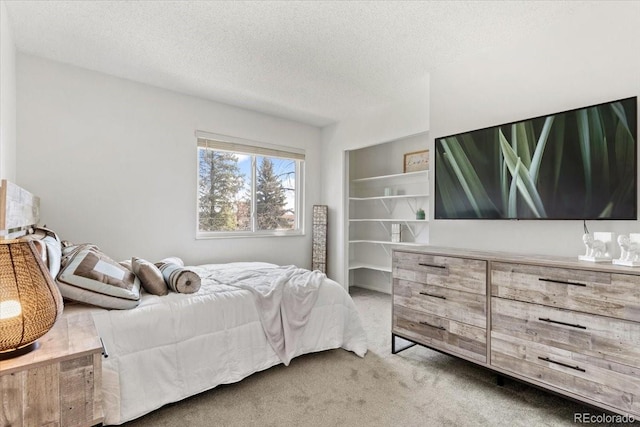 carpeted bedroom with a textured ceiling