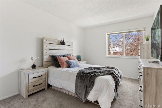 bedroom featuring baseboards, light colored carpet, and a textured ceiling