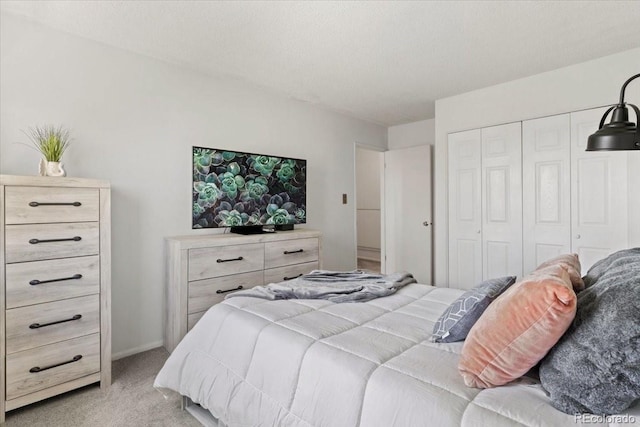 bedroom featuring a closet and light colored carpet