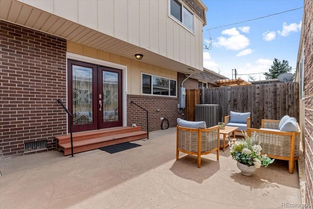 view of patio with an outdoor living space, french doors, cooling unit, and fence