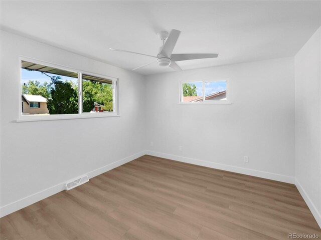 spare room with ceiling fan and wood-type flooring