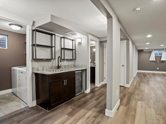 6943 Oak Way, Arvada, CO 80004 - indoor wet bar with washer and dryer, wine cooler, and wood finished floors