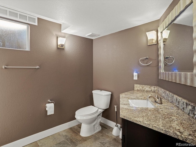 6943 Oak Way, Arvada, CO 80004 - bathroom featuring vanity and a textured wall