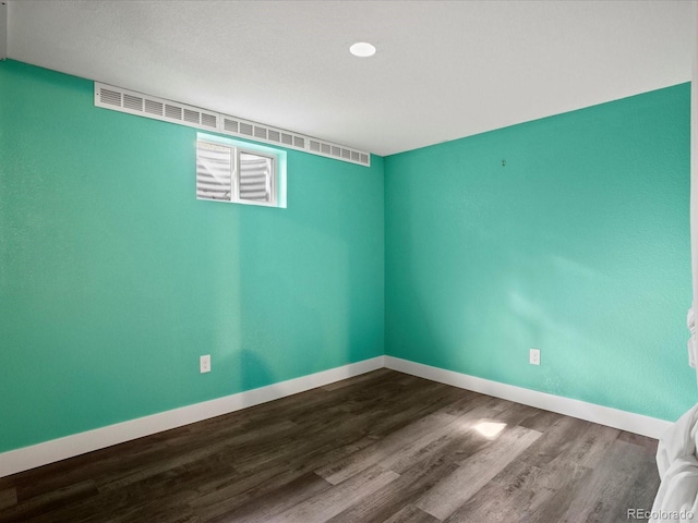 6943 Oak Way, Arvada, CO 80004 - spare room with dark wood-style floors and baseboards