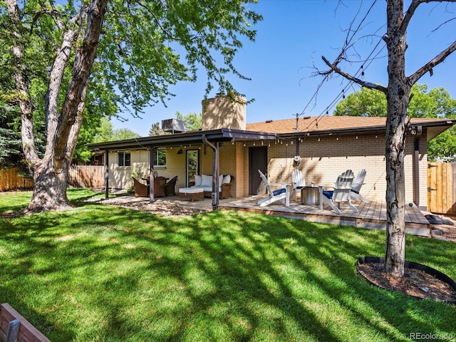 6943 Oak Way, Arvada, CO 80004 - back of house featuring brick siding, an outdoor hangout area, a chimney, and a wooden deck