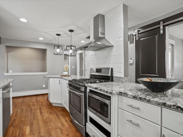6943 Oak Way, Arvada, CO 80004 - kitchen featuring range hood, stainless steel appliances, white cabinetry, light stone counters, and recessed lighting