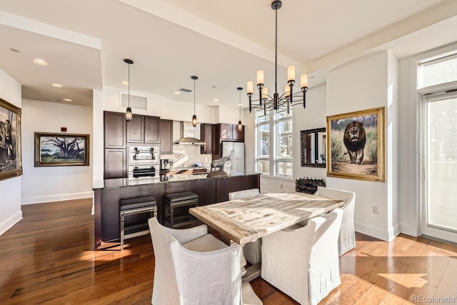 dining area featuring hardwood / wood-style flooring and a chandelier