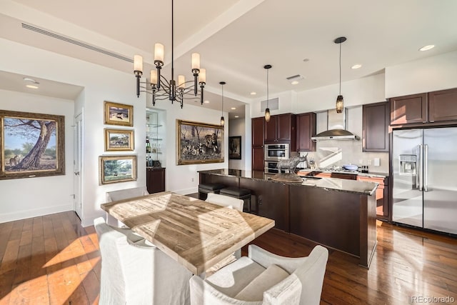 dining area featuring dark wood-type flooring and an inviting chandelier