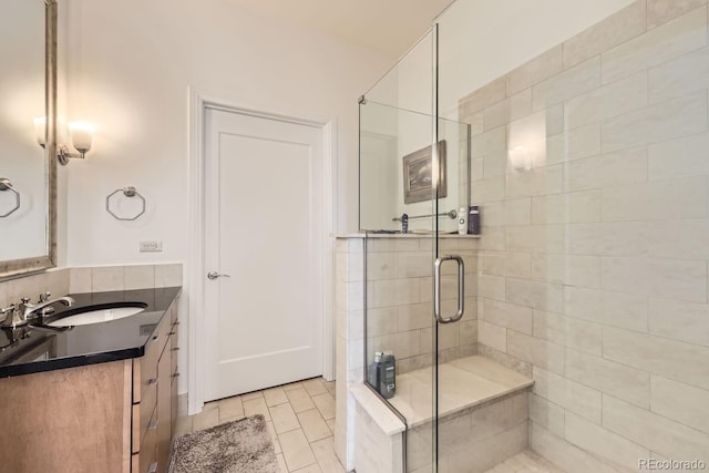 bathroom featuring vanity and an enclosed shower