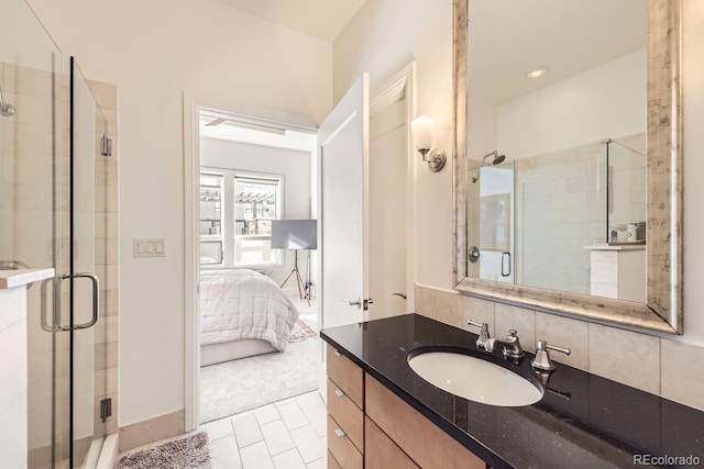 bathroom featuring vanity, tile patterned flooring, decorative backsplash, and walk in shower