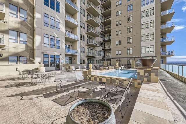 exterior space with a water view and a patio