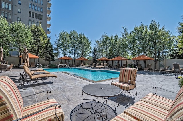 community pool featuring a patio and fence