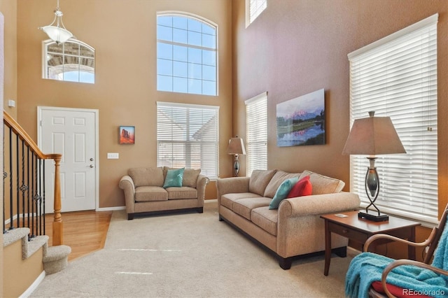 1022 Orion Way, Castle Rock, CO 80108 - living area with stairs, a towering ceiling, carpet floors, and baseboards