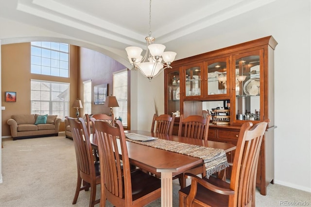 1022 Orion Way, Castle Rock, CO 80108 - dining space with a chandelier, light carpet, arched walkways, and baseboards