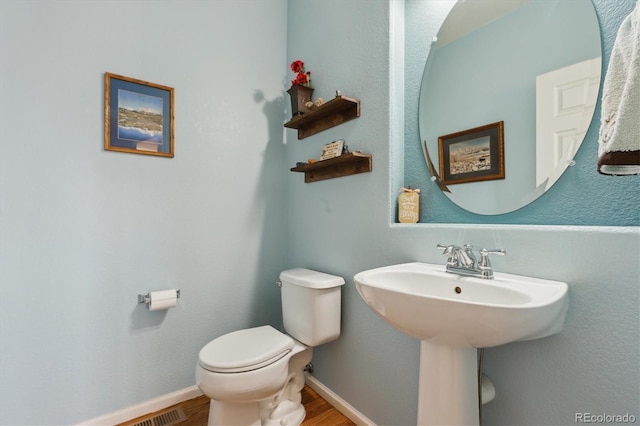 1022 Orion Way, Castle Rock, CO 80108 - bathroom with wood finished floors, toilet, a sink, and baseboards
