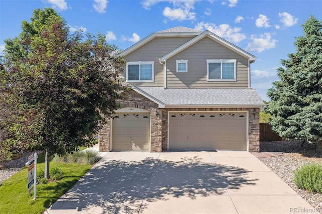 1022 Orion Way, Castle Rock, CO 80108 - view of front of house with a garage, concrete driveway, stone siding, and a shingled roof