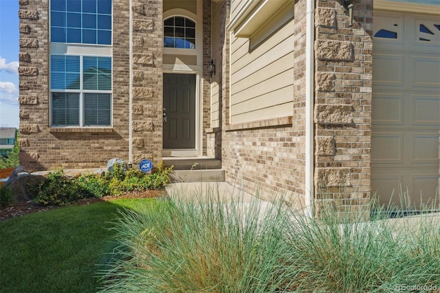 1022 Orion Way, Castle Rock, CO 80108 - doorway to property featuring brick siding and an attached garage