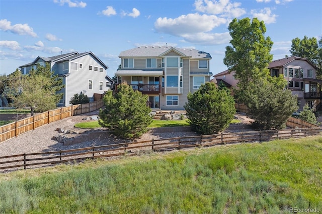 1022 Orion Way, Castle Rock, CO 80108 - back of house featuring a fenced backyard and a balcony
