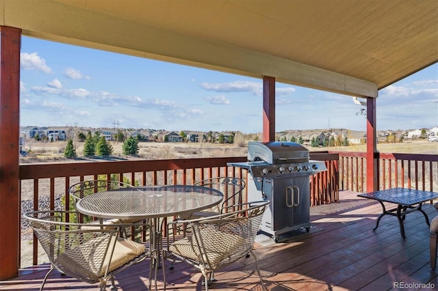 1022 Orion Way, Castle Rock, CO 80108 - wooden deck featuring grilling area, outdoor dining area, and a residential view