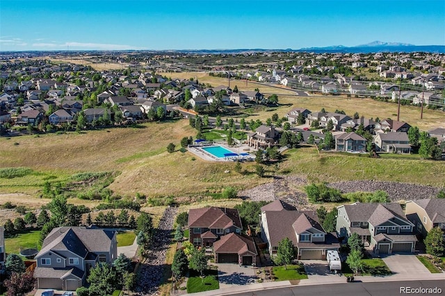 1022 Orion Way, Castle Rock, CO 80108 - aerial perspective of suburban area with a pool area and a mountain backdrop