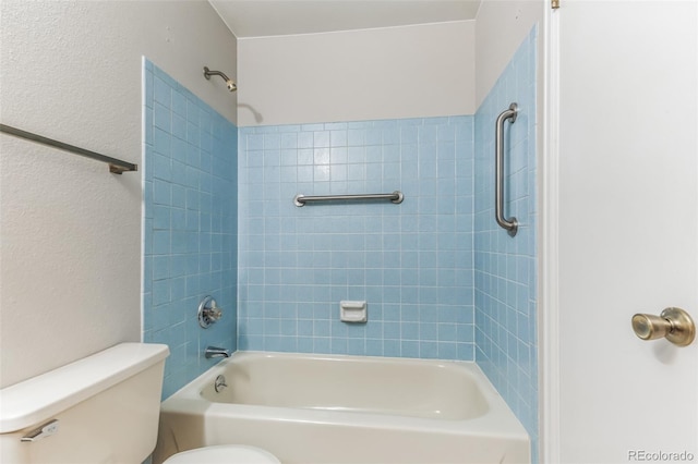 bathroom featuring shower / bath combination and toilet