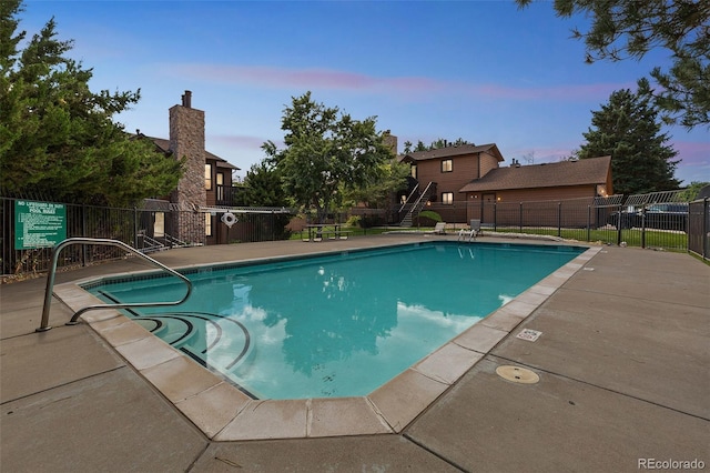 community pool featuring a patio area and fence