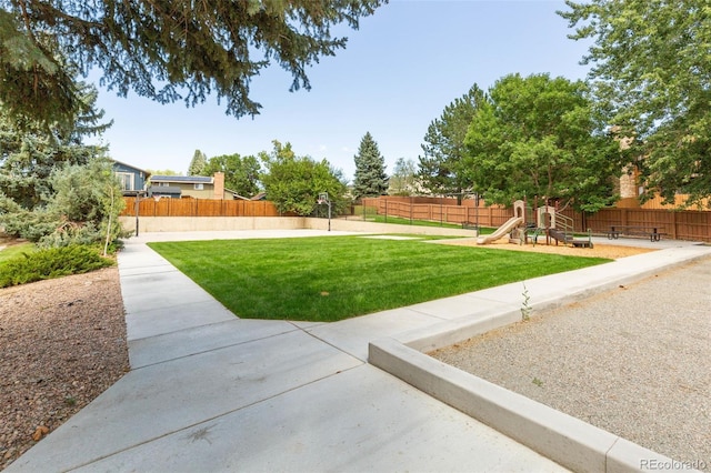 view of yard with a playground and fence