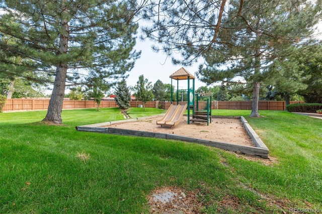 communal playground with fence and a yard