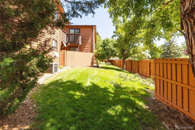 view of yard with central air condition unit and a fenced backyard