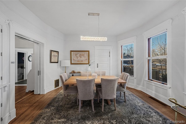 dining space featuring baseboards, visible vents, and dark wood-type flooring