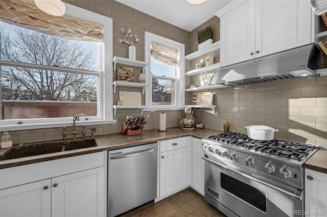 kitchen with open shelves, tasteful backsplash, appliances with stainless steel finishes, white cabinets, and under cabinet range hood