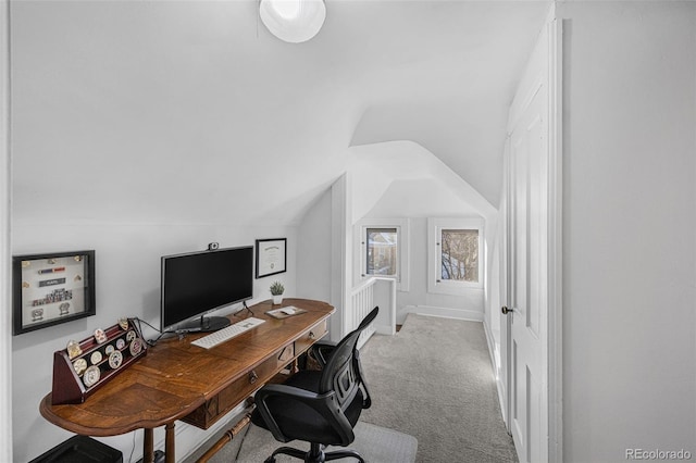 carpeted office featuring lofted ceiling and baseboards